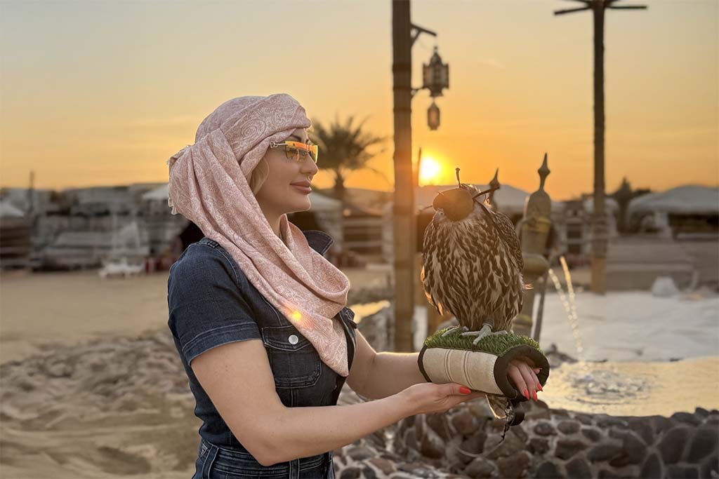 Independent Escort Dubai Joelle Monroe in Dubai with a falcon on her arm.