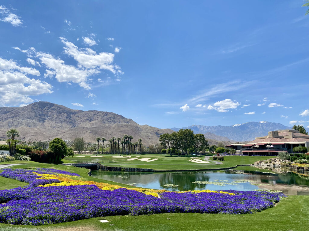 Golf course set against a mountain backdrop.